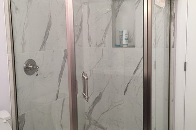 Mid-sized trendy master white tile and porcelain tile marble floor corner shower photo in Calgary with an undermount sink, marble countertops, an undermount tub, a two-piece toilet and white walls