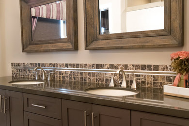 Example of a trendy master multicolored tile and stone tile light wood floor bathroom design in San Luis Obispo with furniture-like cabinets, blue cabinets, marble countertops, a one-piece toilet, beige walls and a drop-in sink
