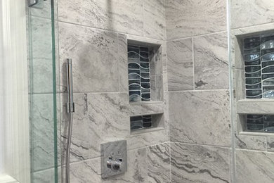 Example of a mid-sized trendy slate floor corner shower design in Other with medium tone wood cabinets, a one-piece toilet, blue walls, a vessel sink, granite countertops and a hinged shower door