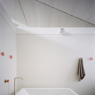 Photo of an industrial bathroom in Sydney with a freestanding tub, white walls and vaulted.