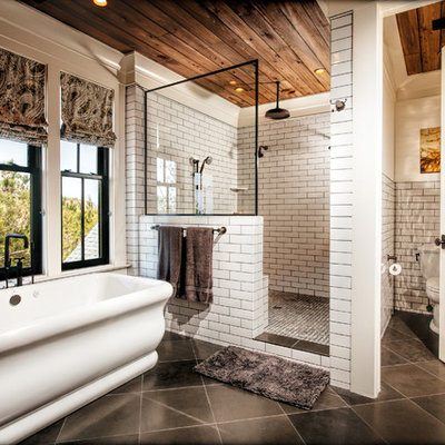 Inspiration for a large timeless master white tile and subway tile porcelain tile and gray floor bathroom remodel in Charleston with a two-piece toilet, furniture-like cabinets, light wood cabinets, white walls and a console sink