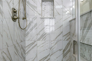 Example of a mid-sized transitional master white tile and porcelain tile porcelain tile and white floor wet room design in Philadelphia with shaker cabinets, a two-piece toilet, beige walls, an undermount sink, quartz countertops, a hinged shower door and beige countertops