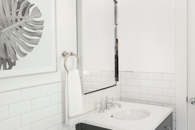 Example of a small cottage kids' white tile and ceramic tile porcelain tile bathroom design in Philadelphia with flat-panel cabinets, gray cabinets, a two-piece toilet, white walls, an undermount sink and solid surface countertops