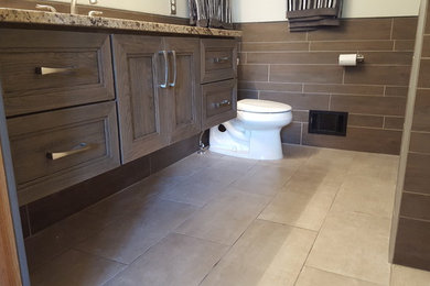Mid-sized transitional 3/4 beige tile and ceramic tile bathroom photo in Detroit with recessed-panel cabinets, granite countertops, beige walls and medium tone wood cabinets
