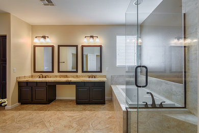 Bathroom - large traditional master travertine tile travertine floor and beige floor bathroom idea in Phoenix with shaker cabinets, dark wood cabinets, a two-piece toilet, beige walls, an undermount sink, marble countertops and a hinged shower door