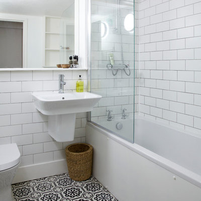 Bathroom - small transitional white tile and subway tile bathroom idea in London with a wall-mount sink, a one-piece toilet and white walls