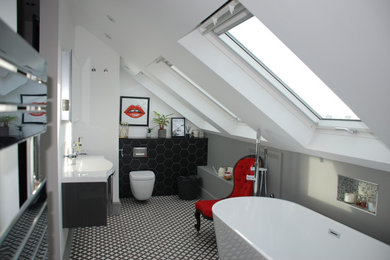 Medium sized contemporary ensuite bathroom in Other with flat-panel cabinets, grey cabinets, a freestanding bath, a walk-in shower, a wall mounted toilet, black and white tiles, mosaic tiles, black walls, ceramic flooring, a wall-mounted sink, engineered stone worktops, black floors, an open shower, white worktops, a wall niche, a single sink, a floating vanity unit and a vaulted ceiling.