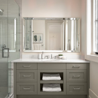 This is an example of a transitional kids bathroom in Calgary with recessed-panel cabinets, grey cabinets, an alcove shower, a one-piece toilet, white walls, porcelain floors, an undermount sink, engineered quartz benchtops, white floor, a hinged shower door, yellow benchtops and stone slab.