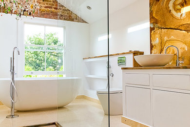 Design ideas for a medium sized contemporary ensuite bathroom in Surrey with freestanding cabinets, a freestanding bath, a walk-in shower and marble worktops.