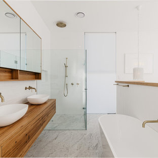 Inspiration for a contemporary bathroom in Sydney with flat-panel cabinets, medium wood cabinets, a freestanding tub, white tile, subway tile, white walls, an undermount sink, wood benchtops, grey floor, brown benchtops, a double vanity and a floating vanity.