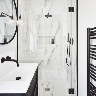 Design ideas for a contemporary shower room bathroom in London with freestanding cabinets, black cabinets, an alcove shower, grey tiles, white tiles, white walls, an integrated sink, solid surface worktops, white floors and white worktops.