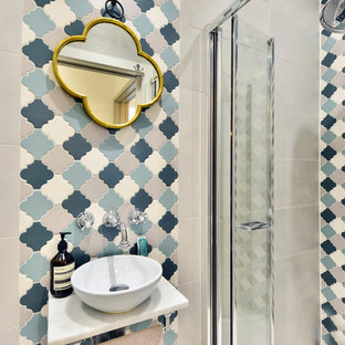 Small mediterranean shower room bathroom in London with a walk-in shower, a hinged door, beige tiles, blue tiles, grey tiles, white tiles, beige walls and a vessel sink.