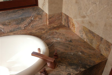 Drop-in bathtub - contemporary beige tile and travertine tile travertine floor and beige floor drop-in bathtub idea in Hawaii with medium tone wood cabinets, an undermount sink, marble countertops and multicolored countertops