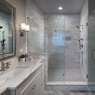 Example of a mid-sized minimalist master gray tile and ceramic tile ceramic tile, gray floor, single-sink and coffered ceiling bathroom design in Atlanta with shaker cabinets, white cabinets, a one-piece toilet, gray walls, an undermount sink, quartz countertops, a hinged shower door, white countertops and a built-in vanity
