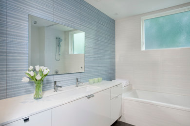 Bathroom - contemporary blue tile bathroom idea in Boston with a trough sink