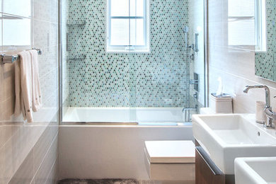 Bathroom - contemporary blue tile and mosaic tile bathroom idea in New York with a one-piece toilet, an integrated sink and dark wood cabinets