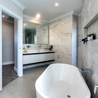 Inspiration for a contemporary master gray tile freestanding bathtub remodel in Sydney with flat-panel cabinets, white cabinets and a vessel sink