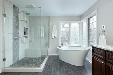 Bathroom - large traditional master white tile and porcelain tile dark wood floor and gray floor bathroom idea in San Francisco with raised-panel cabinets, dark wood cabinets, gray walls, an undermount sink, granite countertops, a hinged shower door and white countertops