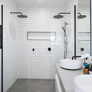 Large contemporary bathroom in Newcastle - Maitland with flat-panel cabinets, white cabinets, white tile, subway tile, white walls, concrete floors, a vessel sink, concrete benchtops, grey floor, an open shower, grey benchtops and a double shower.