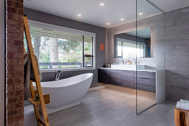 Huge transitional master gray tile and porcelain tile porcelain tile and gray floor bathroom photo in Vancouver with flat-panel cabinets, gray cabinets, a one-piece toilet, gray walls, a vessel sink, quartz countertops and white countertops