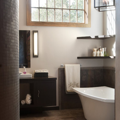 Inspiration for a mid-sized timeless 3/4 mosaic tile and gray tile porcelain tile freestanding bathtub remodel in Philadelphia with flat-panel cabinets, dark wood cabinets, a two-piece toilet, gray walls, a vessel sink and quartz countertops