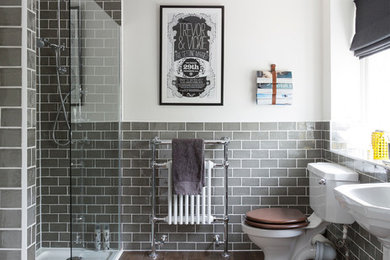 バッキンガムシャーにあるトラディショナルスタイルのおしゃれな浴室 (ペデスタルシンク、アルコーブ型シャワー、分離型トイレ、グレーのタイル、サブウェイタイル、白い壁、濃色無垢フローリング、茶色い床) の写真