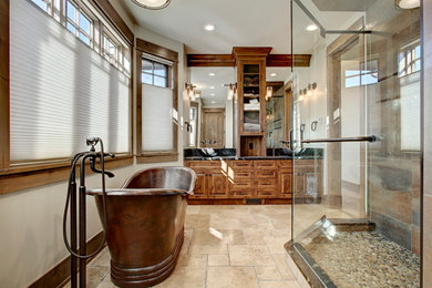 Bathroom - large rustic master beige tile, brown tile, gray tile and stone tile travertine floor and beige floor bathroom idea in Calgary with raised-panel cabinets, medium tone wood cabinets, a one-piece toilet, beige walls, an undermount sink and granite countertops