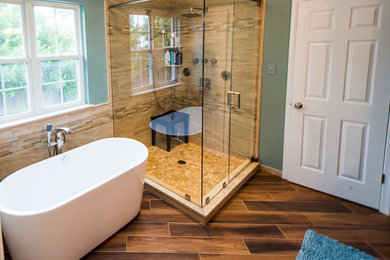 Inspiration for a large transitional master brown floor and dark wood floor bathroom remodel in Philadelphia with dark wood cabinets, green walls, a hinged shower door, an undermount sink and recessed-panel cabinets