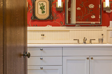 Mid-sized elegant bathroom photo in Austin with white cabinets and red walls