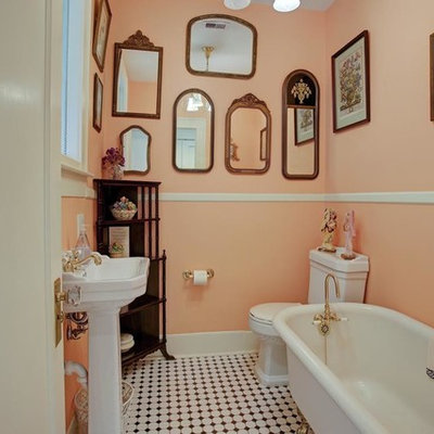 Small arts and crafts black and white tile and ceramic tile mosaic tile floor claw-foot bathtub photo in Houston with a two-piece toilet, pink walls and a pedestal sink