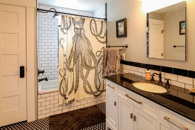 Example of a mid-sized transitional 3/4 white tile and subway tile black floor bathroom design in Denver with recessed-panel cabinets, white cabinets, gray walls, an undermount sink, solid surface countertops and black countertops