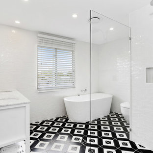 Design ideas for a beach style bathroom in Gold Coast - Tweed with white cabinets, a freestanding tub, white tile, ceramic tile, white walls, a drop-in sink, marble benchtops, multi-coloured floor, a hinged shower door and white benchtops.