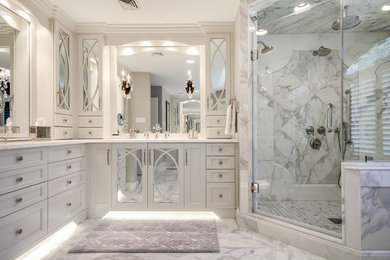 Inspiration for a large transitional master white tile and stone tile marble floor corner shower remodel in Philadelphia with an undermount sink, recessed-panel cabinets, white cabinets, marble countertops and gray walls