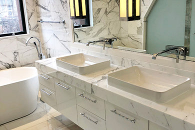 Elegant bathroom photo in Boston with marble countertops