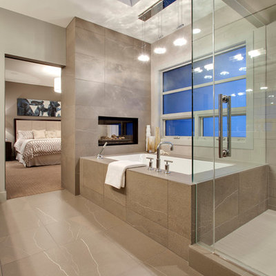Example of a trendy beige tile bathroom design in Calgary with an undermount tub