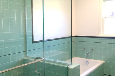 Mid-sized arts and crafts green tile and ceramic tile ceramic tile bathroom photo in Los Angeles with an integrated sink, open cabinets, white cabinets, a one-piece toilet and white walls