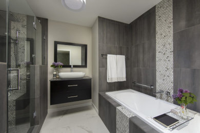 Bathroom - mid-sized contemporary master gray tile and porcelain tile ceramic tile and gray floor bathroom idea in Vancouver with flat-panel cabinets, black cabinets, white walls, a vessel sink, quartz countertops and a hinged shower door