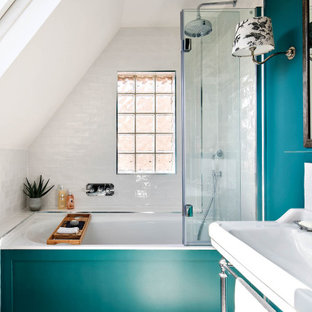 Traditional ensuite bathroom in London with an alcove bath, a shower/bath combination, white tiles, metro tiles, blue walls and a console sink.