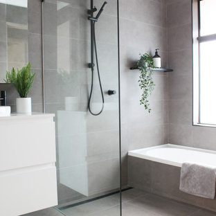 This is an example of a mid-sized modern kids wet room bathroom in Perth with flat-panel cabinets, white cabinets, gray tile, porcelain tile, porcelain floors, a vessel sink, engineered quartz benchtops, grey floor, an open shower, white benchtops, a single vanity, a floating vanity and an alcove tub.