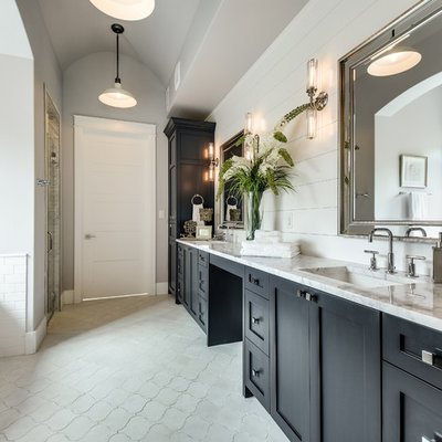 Example of a farmhouse master gray tile and white tile cement tile floor and gray floor bathroom design in Austin with shaker cabinets, black cabinets, gray walls, an undermount sink and a hinged shower door