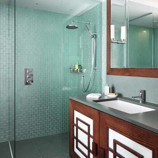 Photo of a mid-sized asian kids bathroom in Other with recessed-panel cabinets, dark wood cabinets, a corner shower, blue tile, green tile, an integrated sink, grey floor, an open shower and grey benchtops.
