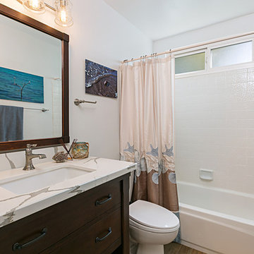 Coastal Bathroom Renovation with Dark Wood Vanity and Matching Mirrior