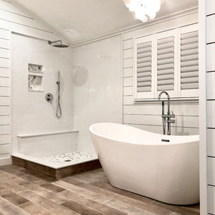 Example of a large country master white tile and subway tile light wood floor and brown floor bathroom design in Bridgeport with recessed-panel cabinets, gray cabinets, white walls, an undermount sink, granite countertops and white countertops