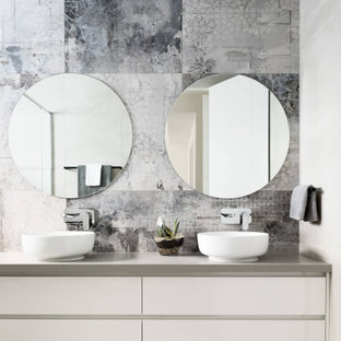 Photo of a contemporary bathroom in Melbourne with flat-panel cabinets, white cabinets, gray tile, a vessel sink, grey floor, grey benchtops and a double vanity.