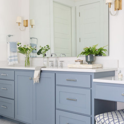 Example of a large beach style master marble floor and gray floor bathroom design in Dallas with shaker cabinets, blue cabinets, an undermount sink, quartz countertops, white countertops and white walls