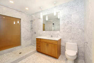 Large contemporary ensuite bathroom in Providence with flat-panel cabinets, marble worktops, white tiles, marble flooring, medium wood cabinets, an alcove shower, a one-piece toilet, marble tiles, grey walls, a submerged sink, grey floors and an open shower.