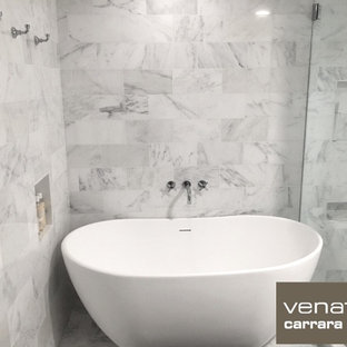 Large elegant master white tile marble floor corner shower photo in Atlanta with white walls