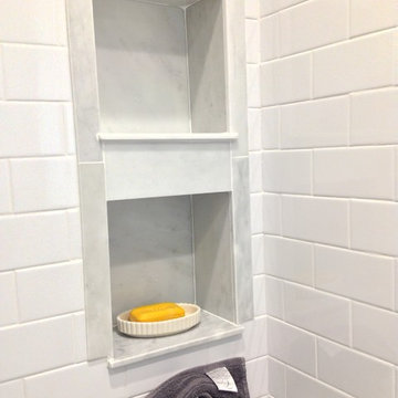 Carrara Marble Recessed Niche in a Subway Tile Shower for a Classic Look