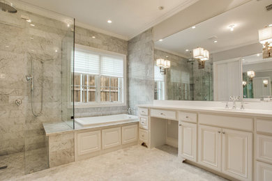 Transitional drop-in bathtub photo in Dallas with raised-panel cabinets, white cabinets, gray walls, quartz countertops and an undermount sink