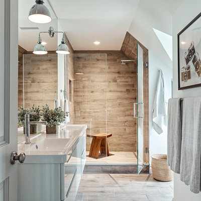 Mid-sized trendy master brown tile and porcelain tile porcelain tile and brown floor alcove shower photo in New York with flat-panel cabinets, white cabinets, white walls, an integrated sink, quartz countertops and a hinged shower door